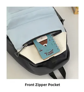 Detailed view of the front zipper pocket on a tri-color contrast minimalist backpack
