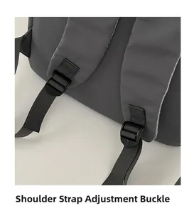 Detail of thickened fabric shoulder strap and adjustable plastic buckle on grey backpack