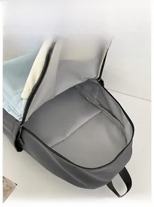 Internal view of the color-block backpack showing spacious main compartment and zipper