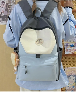 Detail of color-block backpack with cute plush toast pendant for college students