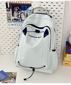 Detail view of large capacity grey backpack with blue trim and front bungee cords