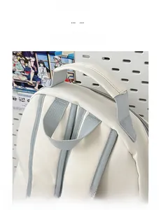 Close-up of wide comfortable handle and gray straps on a cream nylon backpack