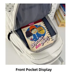 Front pocket detail of a large white backpack showing a notebook inside for storage