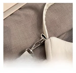 Detailed macro of high-quality metal spring hook and white lychee texture leather strap
