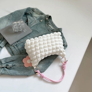 White bubble texture shoulder bag with pink woven handle and floral pendant decor