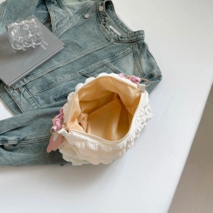 White bubble dumpling shoulder bag with light orange lining and woven knot detail