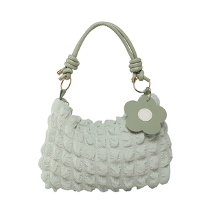 Light green bubble texture shoulder bag with knot strap and flower pendant decor