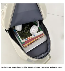 Internal view of beige backpack showing spacious capacity with laptop and A4 magazines