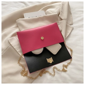Detail of rose red envelope bag showing interior storage for mirror and cards