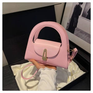 Pink semi-circular handbag with round hollow handle and gold buckle in luxury gift box