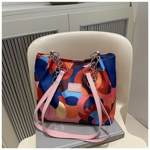 Detail of waterproof nylon shoulder bag with colorful geometric ring pattern and metal chain strap