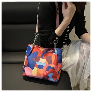 Detail of waterproof Oxford cloth bag with colorful geometric patterns and chain strap