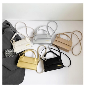 Detailed flat lay of chic retro square handbags in white, silver, beige, yellow and black