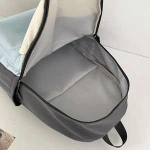 Contrast color backpack with spacious interior main compartment and smooth gray lining
