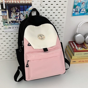 Pink and black color-block nylon backpack with front pocket and circular fashion patch