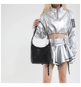 Chic black woven shoulder bag styled on a silver outfit with a sleek minimalist design