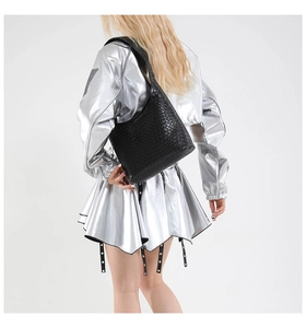 Detail of the woven black leather texture on a spacious shoulder hobo bag for women