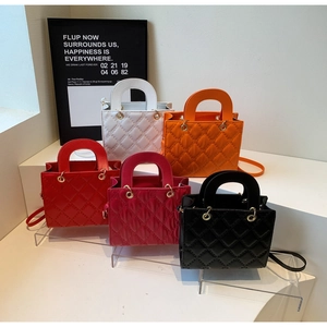Collection of quilted crossbody bags in five vibrant colors with golden metal eyelets