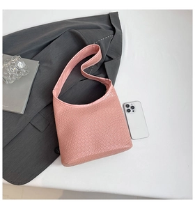 Detail shot of pink crocodile pattern bucket bag with soft PU leather texture