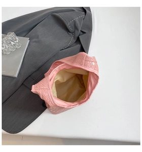 Top view of pink woven hobo bag showing beige lining and zipper details