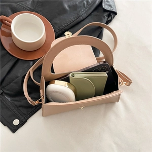 Minimalist beige semi-circle handbag interior showing phone and wallet storage