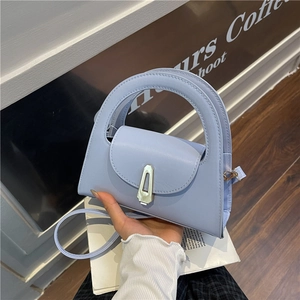 Structured light blue semi-circle handbag with a metal lock and integrated top handle