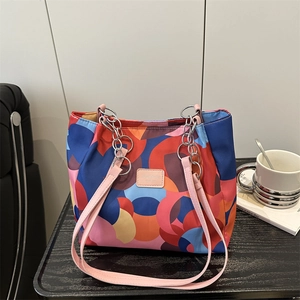 Waterproof nylon tote bag with colorful circle patterns and chain shoulder strap