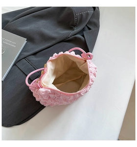 Top view of pink bubble textured handbag showing beige interior lining and gold zipper