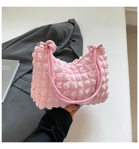 Detailed close-up of pink bubble cloud bag featuring soft pleated texture and knot handle