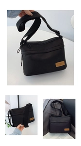 Detail view of black nylon crossbody bag with multi-pockets and adjustable shoulder strap