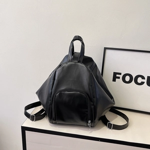 Detailed back view of a black pleated PU leather backpack with adjustable silver straps