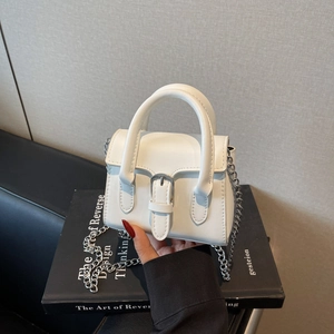 Chic white mini leather crossbody bag with silver chain and metal buckle detail