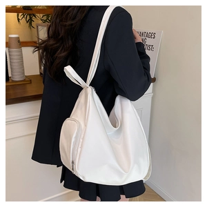 Detail view of large white casual tote bag with side zipper pocket and nylon texture