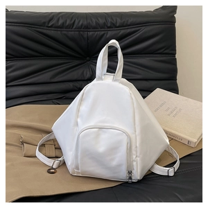 Detailed view of a white geometric backpack with front zipper pocket and silver hardware