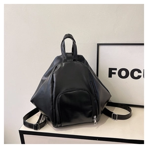 Detailed view of the black geometric pleated backpack featuring a modern PU leather texture
