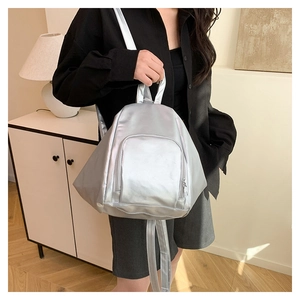 Silver metallic pleated backpack with smooth zipper detail and stylish top handle