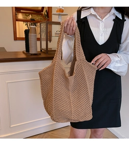 Detailed close-up of light brown knitted hollow tote bag with a spacious interior design