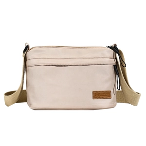 Minimalist beige crossbody bag with multiple compartments and adjustable wide shoulder strap