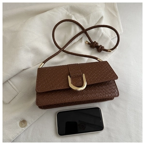 Detail of woven texture shoulder bag in dark brown with gold metal buckle and size reference