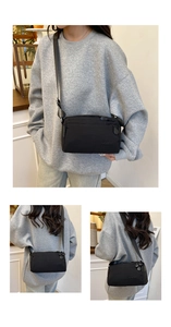Detail view of durable black nylon crossbody bag with adjustable wide strap and logo
