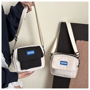Detailed comparison of two minimalist canvas messenger bags in black-white and beige options