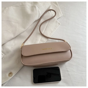 Detail of taupe leather baguette bag with gold FASHION & BAGS lettering and shoulder strap