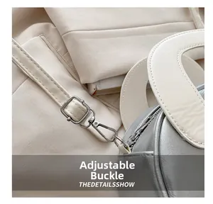 Detail show of adjustable silver buckle and premium leather stitching on shell bag