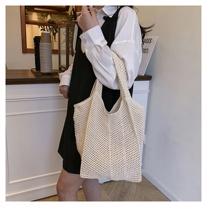 Détail du sac cabas en maille crochetée crème montrant les motifs de tissage ajourés