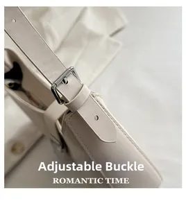 Detail of adjustable silver buckle and premium off-white leather strap on shoulder bag