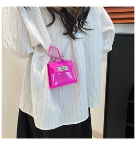 Detail of rose red jelly handbag with silver chain strap and metal twist lock