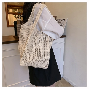 Close-up of cream crochet woven tote bag showing detailed diamond knit texture and pattern