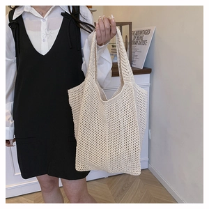 Close-up of beige crochet hollow tote bag showing woven mesh texture and capacity