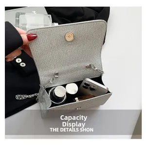 Internal view of silver glitter chain bag showing capacity for phone and lipstick