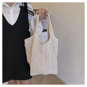 Detailed shot of beige crochet tote bag showing hollow knit texture and spacious design
